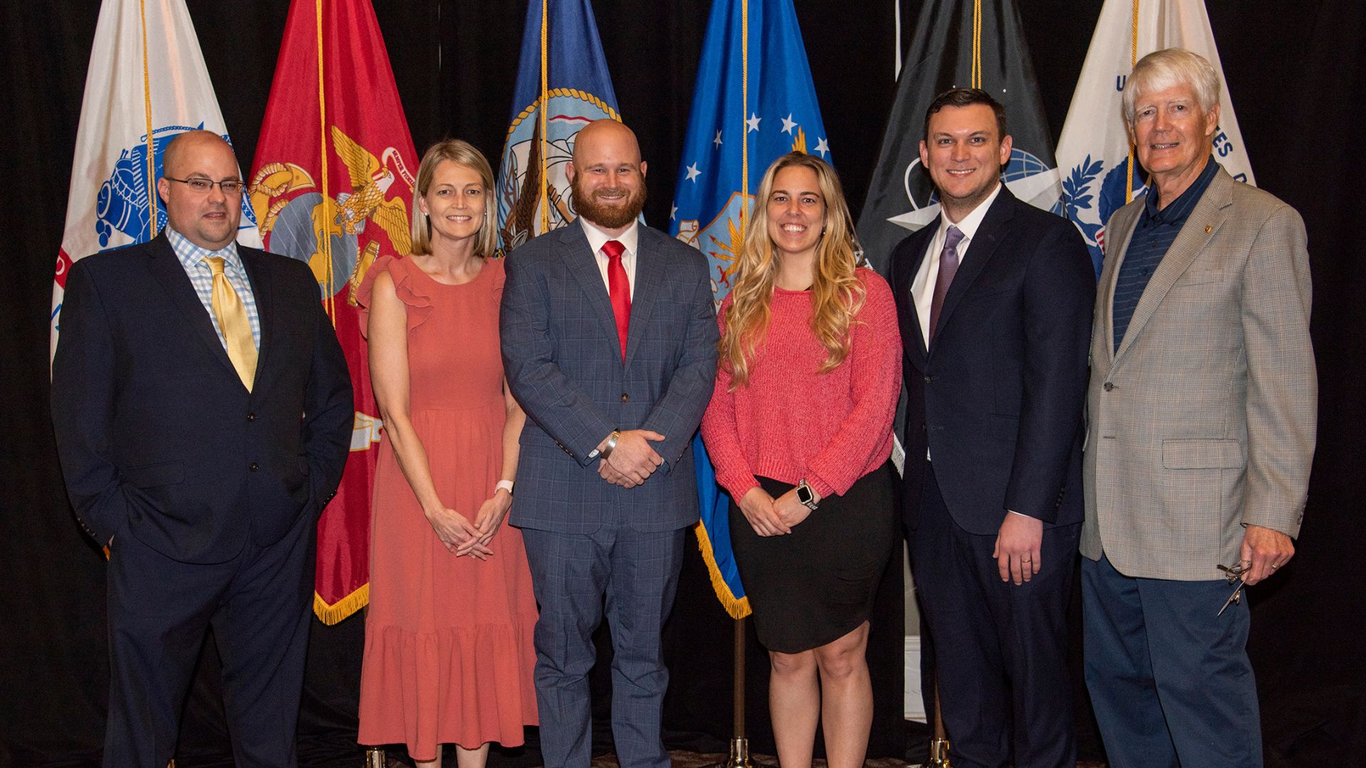 People in front of flags.