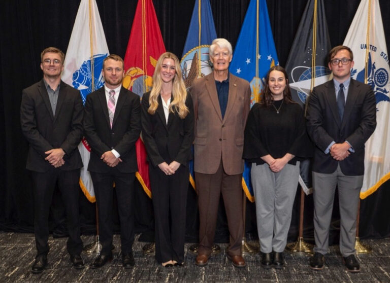SVRC Donors standing in front of a group of flags.